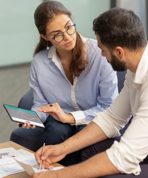 My gadget. Serious bearded man looking at his partner and putting sign on document